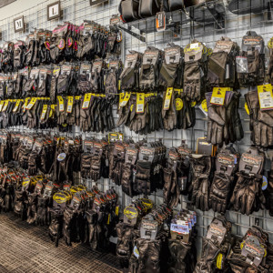 A full wall of motorcycle gloves